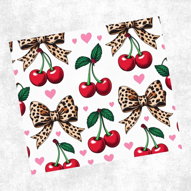 May include: A repeating pattern featuring red cherries with green leaves and brown leopard print bows on a white background. Small pink hearts are scattered throughout the design. The cherries are a vibrant red.