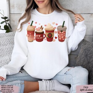 May include: White sweatshirt featuring a graphic of four crochet-style coffee drinks with heart accents. One mug says "True Love." The design includes pink, red, and brown colors. The image also includes the text "THIS IS A DIGITAL PRODUCT OF THE DESIGN ONLY. NO PHYSICAL PRODUCT WILL BE SENT. Png digital download."