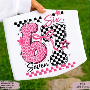 May include: White graphic design featuring the numbers "67" with a pink leopard print and a black and white checkered pattern. The word "Six" and "Seven" are also included, along with pink stars and a bow. The text "THIS IS A DIGITAL PRODUCT OF THE DESIGN ONLY. NO PHYSICAL PRODUCT WILL BE SENT" is also included.