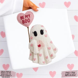 May include: A crocheted ghost holding a pink heart-shaped balloon that says "BE MY BOO". The ghost has pink heart accents and is holding a pink envelope. The image is a digital download.