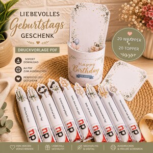 May include: A printable PDF set for birthday gifts featuring a cylindrical container and twenty wrappers with matching toppers. The items display floral accents, balloons, gift boxes, and German text including "Alles Gute für dich!" and "Happy Birthday TO YOU."