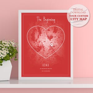 May include: A white framed print with a red background and a white heart-shaped outline of a city map. The text "The Beginning" is at the top of the print and "ROMA" is at the bottom. The text "DIGITAL DOWNLOAD YOUR CUSTOM CITY MAP" is in a white circle in the upper right corner.