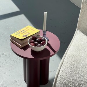 A cozy round coffee table for your living room, entryway, or bedside
