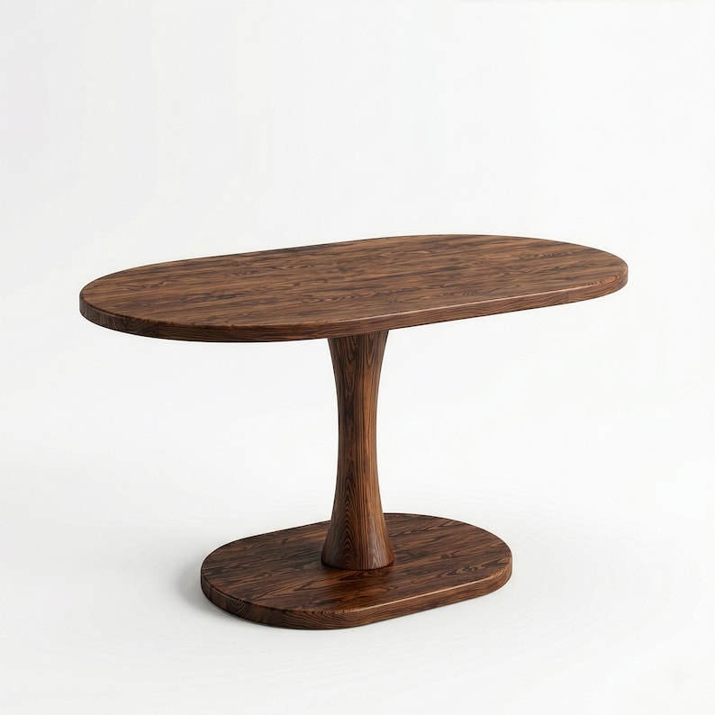 Puede incluir: Una mesa de madera de color marr&oacute;n oscuro con un tablero ovalado sostenido por una base de pedestal central &uacute;nica que se conecta a una base de suelo ovalada. La veta de la madera es visible en toda la estructura de este mueble.