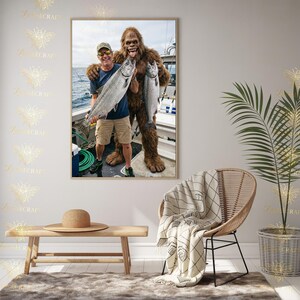 May include: A framed photograph shows a man and a Bigfoot-like creature holding large fish on a boat. The man wears a blue shirt, khaki shorts, and a cap. The Bigfoot is covered in brown fur. The background shows water and a cloudy sky.