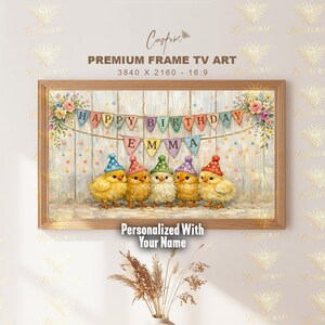 May include: A framed print showing five chicks in party hats beneath a banner reading "Happy Birthday Emma." The artwork has a rustic style, with floral accents and confetti, perfect for a child's birthday.