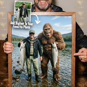 May include: A framed photo featuring a man holding a fish next to a Bigfoot figure. The image includes the text "Add Bigfoot To Your Favorite Photo". The frame is made of wood.