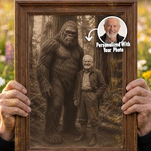 May include: A framed sepia-toned print featuring a large Bigfoot figure standing next to a man. A circular inset shows a photo of a smiling man with the text "Personalized With Your Photo". The frame is brown.