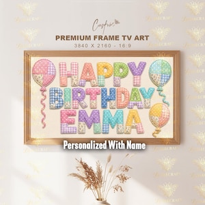 May include: A framed artwork with the words "HAPPY BIRTHDAY EMMA" in colorful, patchwork-style letters. The artwork includes decorative balloons and the text "Personalized With Name". The frame is a light brown color.