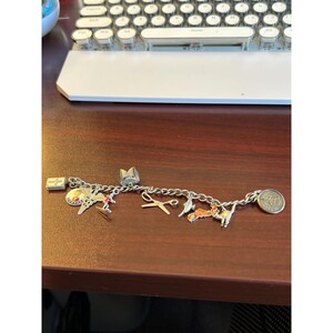 Vintage Sterling Silver charm bracelet with 10 charms (4 are stamped sterling);