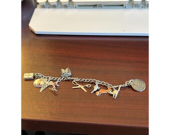 Vintage Sterling Silver charm bracelet with 10 charms (4 are stamped sterling);