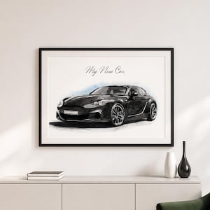 Op de afbeelding: Een ingelijste kunstdruk met een zwarte sportwagen in aquarel-stijl. De tekst "My New Car" staat in een cursief handschrift boven het voertuig. Het kunstwerk zit in een eenvoudige zwarte lijst en benadrukt de strakke lijnen van de auto.
