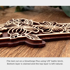May include: Close-up of a wooden floral design cut on a Glowforge Plus using 1/8 inch Baltic birch. The bottom layer is stained and the top layer is left natural.