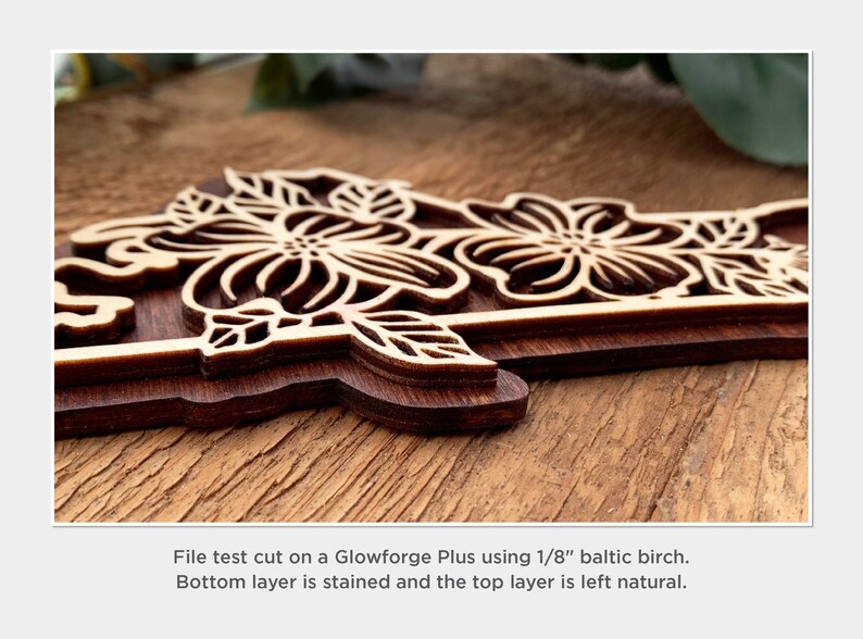 May include: Close-up of a wooden floral design cut on a Glowforge Plus using 1/8 inch Baltic birch. The bottom layer is stained and the top layer is left natural.
