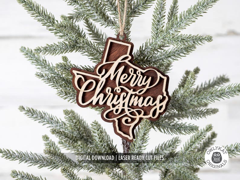May include: A wooden Christmas ornament in the shape of Texas, with the words "Merry Christmas" cut out in a decorative font. The ornament is brown with a lighter wood color for the text and is hanging from a string.