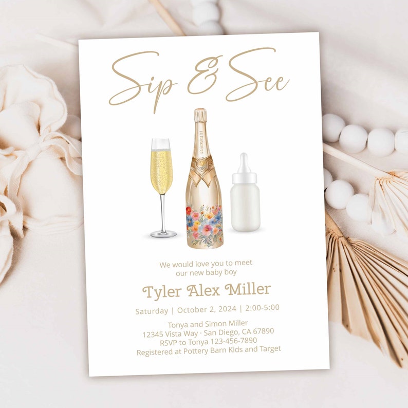 May include: A white card with gold text announcing a Sip & See for a new baby boy named Tyler Alex Miller. The card features a champagne bottle with floral designs, a champagne flute, and a baby bottle.