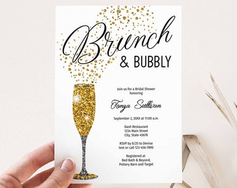 May include: A white invitation card with gold glitter accents. The card features a champagne flute with gold glitter and the text "Brunch & Bubbly" in black cursive font. The invitation is for a bridal shower honoring Sonya Sullivan. The date, time, location, RSVP information, and registry details are included.