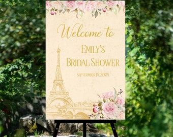Könnte beinhalten: Ein Willkommenszeichen für eine Bridal Shower mit Pariser Thema. Das Schild zeigt eine Skizze des Eiffelturms, einer Brücke und ein Blumenmuster mit rosa Rosen. Der Text auf dem Schild lautet "Willkommen zu Emily's Bridal Shower am 14. September 2024".