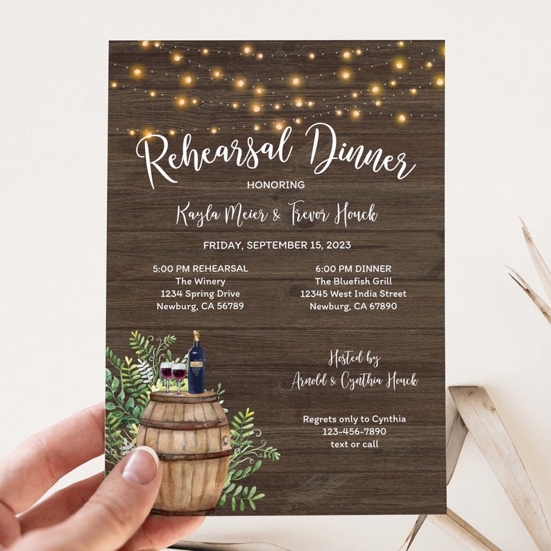 May include: Rehearsal dinner invitation with a rustic wood background and string lights. The invitation is for Kayla Meier and Trevor Houck and includes the date, time, and location for the rehearsal and dinner. The invitation also includes a watercolor illustration of a wine barrel with two glasses of wine and a bottle of wine.