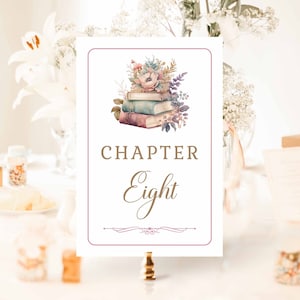 May include: A white card with a pink border and a floral illustration of a stack of books. The text "CHAPTER Eight" is written in brown script.