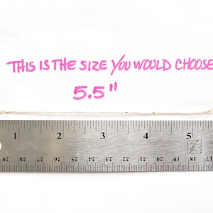 May include: A ruler measuring 5.5 inches with a piece of string laid across it. The text "THIS IS THE SIZE YOU WOULD CHOOSE 5.5"" is written in pink above the ruler.