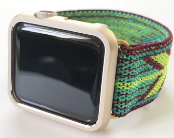 May include: A gold-colored Apple Watch with a black screen and a green, red, and blue patterned band.