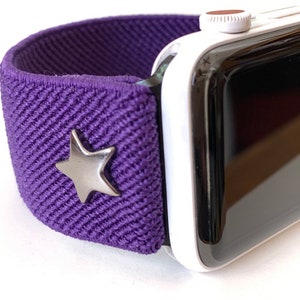 May include: A purple elastic Apple Watch band with a silver star charm.
