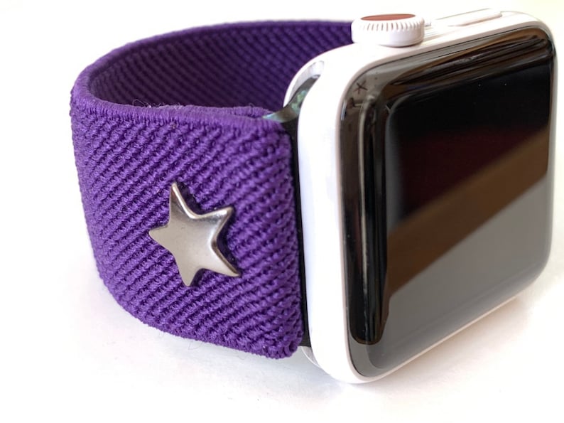 May include: A purple elastic Apple Watch band with a silver star charm.