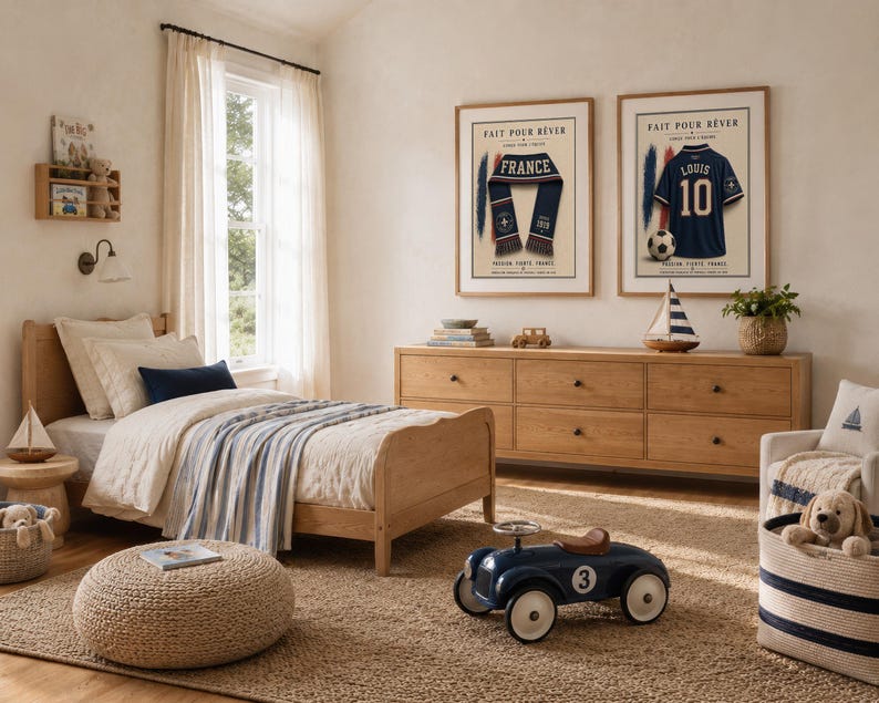 May include: A bedroom featuring a light wood bed frame with cream bedding and a blue striped throw, a matching six-drawer dresser, and two framed prints on the wall. One print shows a blue scarf, the other a blue jersey with the text FAIT POUR R&Ecirc;VER.