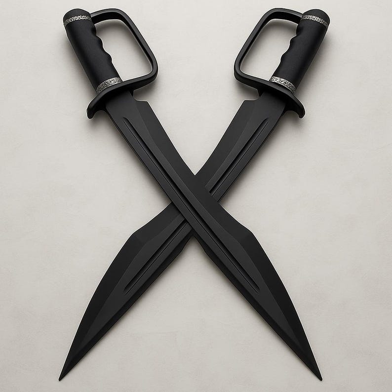 May include: Two black swords are crossed. Each sword has a D-shaped handle and a silver band near the hilt. The blades are long and pointed, with a matte finish. The swords are set against a light background.