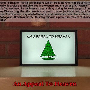 May include: A framed print of the "An Appeal To Heaven" flag, a historical symbol of the American Revolution. The flag features a white background with a green pine tree in the center and the text "An Appeal To Heaven" at the top.