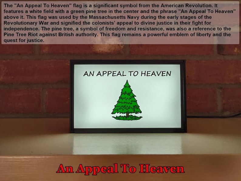May include: A framed print of the "An Appeal To Heaven" flag, a historical symbol of the American Revolution. The flag features a white background with a green pine tree in the center and the text "An Appeal To Heaven" at the top.