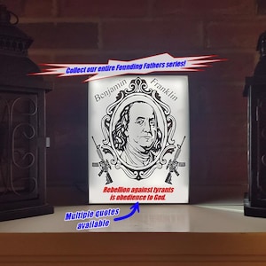 May include: A lit panel with a portrait of Benjamin Franklin, framed with the text "Benjamin Franklin." The panel includes the quote "Rebellion against tyrants is obedience to God." and two rifles. The text "Collect our entire Founding Fathers series!" is also present.