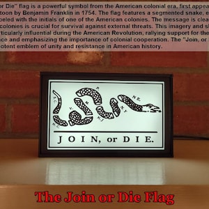 May include: A black and white image of the "Join, or Die" flag, a historical symbol of unity during the American Revolution. The flag features a segmented snake with the initials of the 13 colonies, and the text "JOIN, or DIE."
