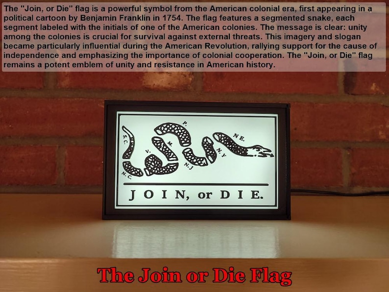 May include: A black and white image of the "Join, or Die" flag, a historical symbol of unity during the American Revolution. The flag features a segmented snake with the initials of the 13 colonies, and the text "JOIN, or DIE."