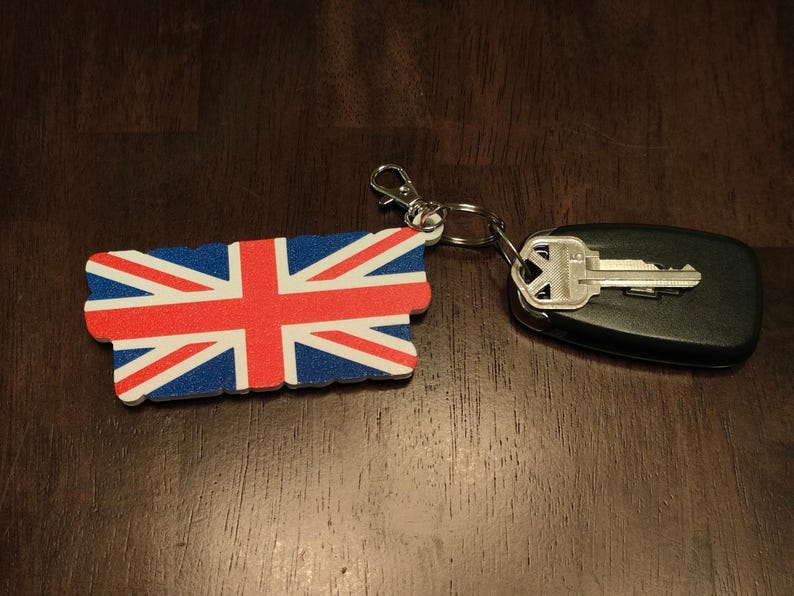 K&ouml;nnte beinhalten: Eine wei&szlig;e Keramik-Tasse mit schwarzem Henkel und dem Text "But First, Coffee" in schwarzer, handschriftlicher Schrift. Die Tasse steht auf einer wei&szlig;en Oberfl&auml;che.