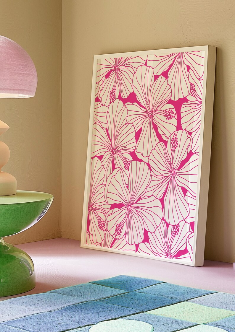 May include: A framed print with a white background and a pink floral pattern. The flowers are stylized and have a graphic design.