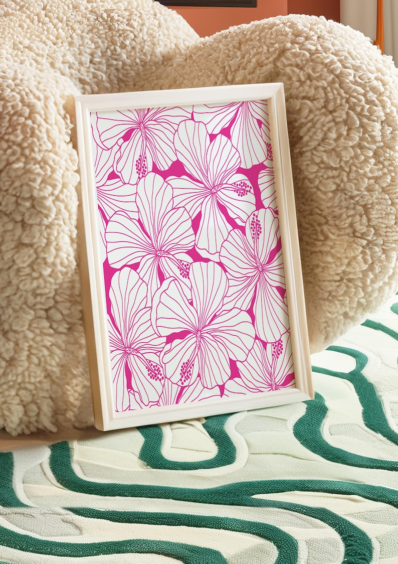 May include: A framed print with a white background and a pink floral pattern. The flowers are outlined in white and have a pink fill.