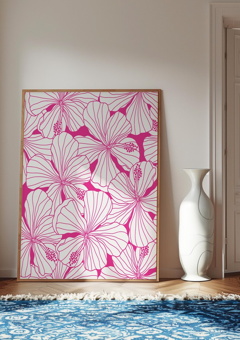May include: A framed print featuring a white floral pattern on a bright pink background. The print features a repeating pattern of hibiscus flowers.