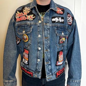 May include: A set of three ceramic mugs with a speckled, matte finish. The mugs are in shades of cream, light gray, and dark gray. Each mug has a simple, minimalist design and a rounded handle. The mugs are likely for coffee or tea.