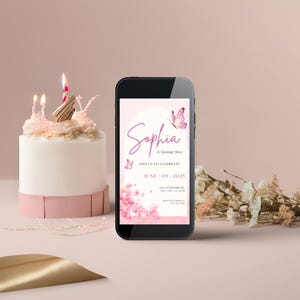 May include: A pink and white birthday invitation on a smartphone screen with a pink butterfly design and the text "Sophia is Turning Three" and "June 03 2025".