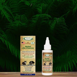May include: A green and white bottle of Mad About Organics Herbal Ear Cleanser. The bottle is labeled with the product name, a no-sting formula, and a concentrated formula for all animals. The bottle is 2 fl oz / 59 ml.