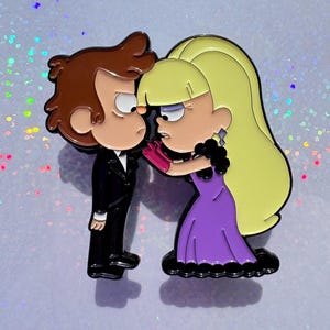 May include: Enamel pin featuring cartoon characters, a boy in a black suit and a girl in a purple dress. The girl is touching the boy's face with a pink glove. The pin has a glossy finish and is set against a glittery background.