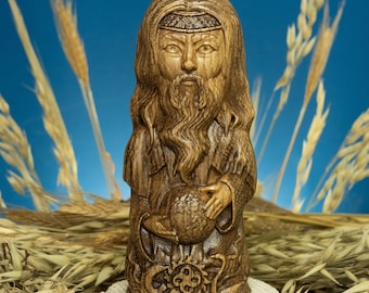 May include: A wooden carving of a bearded figure holding a sphere. The figure is wearing a robe and has a crown on its head. The carving is set against a background of wheat stalks.