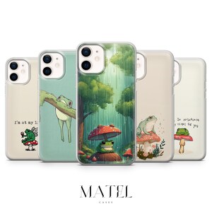 May include: A collection of phone cases featuring whimsical frog illustrations. Designs include a frog on a branch, under a mushroom umbrella, and on a mushroom. Each case has a unique background and text.