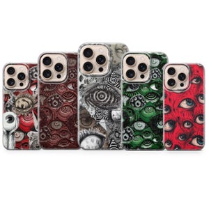 May include: Five smartphone cases arranged in a row, each featuring a detailed, repeating graphic pattern of human eyes. The designs include variations in red, dark brown, black and white, green, and a vibrant red color palette.