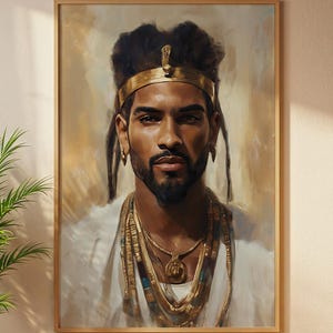 May include: A framed portrait of a man with dark skin, adorned with gold jewellery and a gold headdress. The man is wearing a white garment, with a beard and dark hair. The artwork has a warm colour palette and a regal theme.