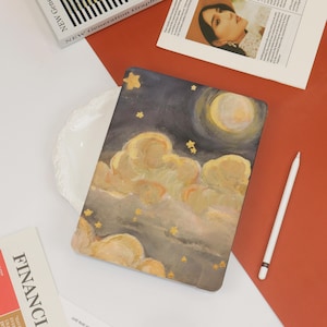 May include: A laptop sleeve with a painted design of a night sky with clouds and stars. The sky is a dark blue with a large, white moon in the upper right corner. The clouds are a light yellow and white, and the stars are a bright gold.