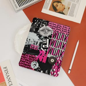 May include: A black and white tablet case with a collage design featuring the words "WORK" in pink, a lip graphic, and the words "WHAT EVER". A white stylus and a magazine are also visible.