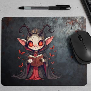 Dark chibi witch mouse pad featuring a cute demon girl with glowing red eyes, gothic robes, and ancient spellbook. This high-resolution PNG design is perfect for gaming setups, horror-themed desks, occult lovers, and digital art fans. The creepy yet adorable aesthetic makes it an ideal pick for gothic decor, fantasy enthusiasts, and witchcraft-inspired designs.